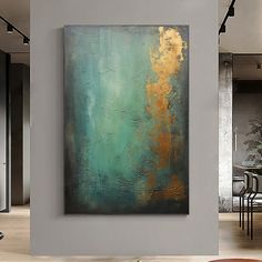 an abstract painting hangs on the wall in a living room