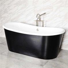 a black and white bath tub sitting on top of a tiled floor