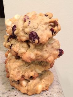 three cookies stacked on top of each other with cranberries and white chocolate chips