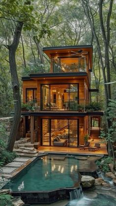 a house in the woods with a pool and stairs leading up to it's second story