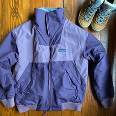 A Classic Patagonia Staple Is Back. Combining Two Of Our Most Beloved Fabrics, This Classic Jacket Has A 100% Recycled Nylon Baggies Shell Fabric For Mild Weather Protection And Is Lined With Supersoft 100% Recycled Polyester Fleece For Next-To-Skin Softness. Fair Trade Certified Sewn. Size Small Piton Purple Past Season Like New Condition Patagonia Jacket, Classic Jacket, Patagonia Womens, Stuffed Shells, Patagonia, Like New, Bomber Jacket, Jackets For Women, Jackets & Coats