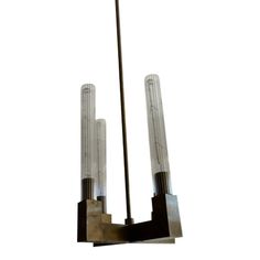 an art deco chandelier with three glass tubes hanging from it's sides