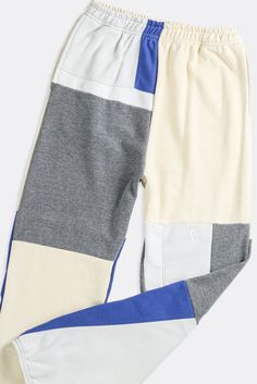 We updated our classic patchwork sweatpants with a straight leg fit for the perfect stack. Upcycled from 3 thrifted sweatshirts. Sourced and reworked in Canada.DetailsSize: Women's S, Men's XS*Unisex fit, men size up Condition: Good Vintage Condition Material Composition: 100% polyesterColour: Blue, grey, cream White Cotton Color Block Pants, Casual Cotton Sweatpants With Contrast Color, White Color Block Cotton Pants, Sporty Cotton Sweatpants With Contrast Color, Color Block Cotton Bottoms For Loungewear, Cotton Color Block Bottoms For Loungewear, Cotton Patchwork Bottoms For Loungewear, Casual Cotton Patchwork Sweatpants, Cotton Color Block Loungewear Bottoms