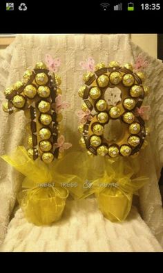 two yellow bows are sitting next to each other in front of a white lace chair