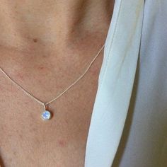 A cute and dainty little rainbow moonstone drop necklace in sterling silver. Comes on your choice of a 16 or an 18 inch sterling silver chain with the artist's tag attached at the clasp. The rainbow moonstone is 5mm in diameter, round, faceted, and natural. Comes with a lifetime warranty, a care card, and a gift box. You can find the matching stud earrings here: https://www.etsy.com/listing/633196724/moonstone-drop-studs-xl-in-sterling?ref=shop_home_active_1 Also available in 14ky gold: https:// Dainty White Birthstone Necklace In Sterling Silver, Care Card, Drop Necklace, Moon Stone, Sterling Silver Chain, The Rainbow, Rainbow Moonstone, Sterling Silver Chains, Moonstone