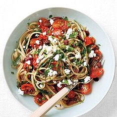 a white plate topped with pasta and tomatoes