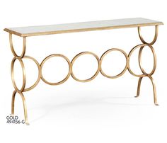 a gold and white console table with circles on it