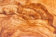 a close up view of a wooden surface with wavy lines on the wood and in the center