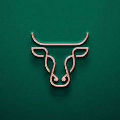 a metal bull head on a green background