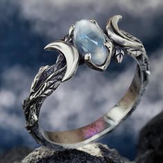 Silver Branches Moonstone Ring 🌙✨ ✨ Discover a Touch of Celestial Beauty! Elevate your style with our Silver Branches Moonstone Ring--a stunning piece that captures the magic of the cosmos. Crafted from 925 sterling silver, this ring showcases a unique design inspired by delicate branches, adorned with a mesmerizing moonstone that reflects a beautiful rainbow of colors. 🌈 💖 Why You'll Love It: Unique Design: Each ring is handcrafted, making it a one-of-a-kind treasure just for you or your lov Silver Mystical Crystal Birthstone Ring, Silver Crystal Birthstone Ring, Mystical Silver Crystal Ring For Anniversary, Silver Mystical Crystal Ring For Anniversary, Ethereal Jewelry For Anniversary With Moon Phase, Ethereal Silver Moonstone Jewelry, Celestial Silver Jewelry For Promise, Ethereal Sterling Silver Gemstone Jewelry, Silver Celestial Jewelry For Promise