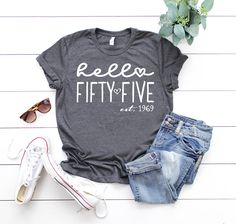 a t - shirt that says keep fifty five on it next to some jeans and sunglasses