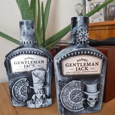 two bottles of gentleman jack are sitting on a table