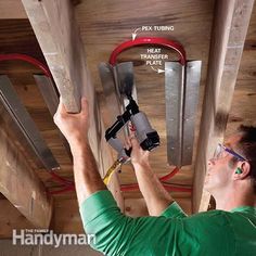 a man is working on the ceiling in his house with tools and wires attached to it