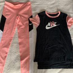 Featuring A Nwot Girls Nike Drift Fit Legging Set Coral Pink/ Black Coral Pink Legging (L) Shirt Size (M) This Set Comes With An Additional Free Pair Of Black Nike Leggings With Coral Pink Nike Logo. Size Xl Body 83% Polyester, 17% Spandex Cute Set!!!! Nike Sporty Sports Sets, Sporty Cotton School Sets, Sporty Spring Gym Sets, Casual Pink Short-sleeve Activewear, Pink Short Sleeve School Sets, Pink Stretch Cotton Activewear, Pink Cotton Sportswear Activewear, Trendy Sports Sets For Spring, Casual Pink Activewear For Sports