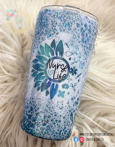 a blue and white tumbler sitting on top of a fur covered floor with the words maybe life written on it