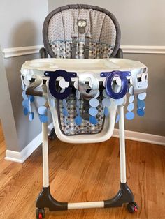 a baby's high chair with blue and white decorations