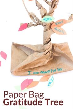 the paper bag gratitude tree is on display