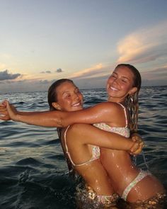 two girls in the water hugging each other