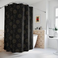 a bathroom with a black shower curtain next to a bath tub