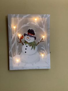 a snowman with lights in the background