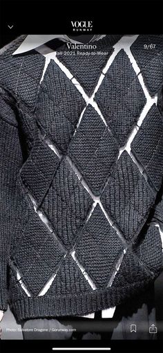 an image of a black and white sweater on a cell phone screen with the word vode written below it