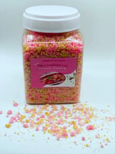 a jar filled with pink and yellow sprinkles