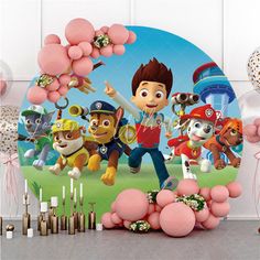 a birthday party scene with balloons, candles and paw patrol characters on the cake topper