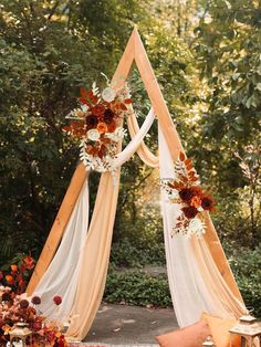 an outdoor wedding setup with flowers and candles