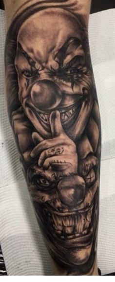 a man's leg with an evil clown tattoo on it