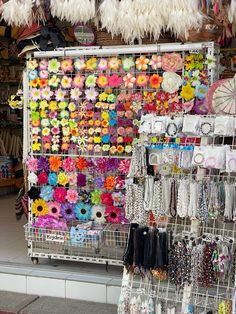 there are many items for sale in the store and on this rack is an umbrella