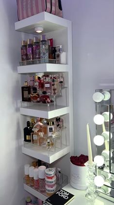 a white shelf filled with lots of cosmetics and other personal care items next to a mirror