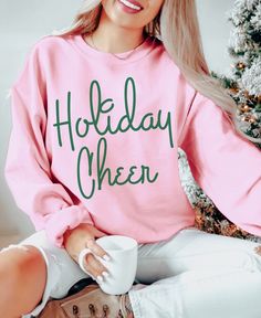 Celebrate the holidays, but make it fashion in our cozy and trendy Holiday Cheer sweatshirt. Wear it all season long to all your holiday outings, Christmas Parties, seeing Christmas lights, baking or just curled up in front of the fire at home. It also makes great Christmas gifts for the fashion lovers and minimalists on you list.  Holiday Cheer Sweatshirt, Women's Christmas Shirt, Trendy Holiday sweatshirt, Aesthetic sweatshirt, Retro Christmas shirt, gifts for her A sturdy and warm sweatshirt Vinyl Sweatshirt Ideas Cricut, Pink Christmas Sweatshirt, Cute Christmas Sweatshirts, Christmas Sweatshirts Vinyl, Cricut Christmas Gifts, Holiday Sweatshirts, Christmas Shirts For Women, Retro Christmas Shirt, Aesthetic Sweatshirt