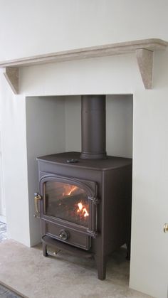 a wood burning stove sitting inside of a living room