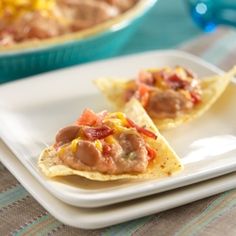 two pieces of nachos on a white plate