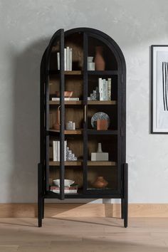 Black wood cabinet with glass doors and brown wood shelves sits against a grey wall. Four Hands Furniture, Dining Cabinet, Glass Front Door, Oak Cabinets, Modern Storage, Burke Decor, Stylish Storage, My New Room, Black Solid