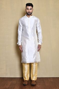 Blue bundi with contrasting floral pattern embroidered front. Comes with white kurta and golden pant. - Aza Fashions White Sherwani With Gota Work For Navratri, Navratri White Sherwani With Gota Work, White Nehru Jacket With Gota Work For Eid, White Bandhgala For Puja Transitional Season, Transitional Season White Bandhgala For Puja, White Bandhgala For Festive Puja, White Bandhgala For Puja And Festive Occasions, White Festive Bandhgala For Puja, White Bandhgala For Diwali Puja