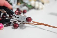 someone cutting up berries with scissors on a table