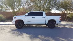 a white truck is parked on the street