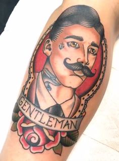 a man with a mustache and name tattoo on his arm that says gentleman in the middle