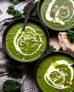 three bowls filled with green soup on top of a table