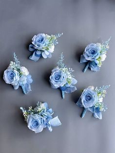 blue flowers are arranged on a gray surface