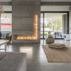 a large living room with a fireplace and couches in front of the fire place