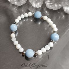 I Can Make This Bracelet In 6.5 To 8.5 Inches If You Send Me A Message. Standard Length Is 7.5 Inches. -Introducing The Celik Crystals Original Design Bracelet, A Stunning Piece Of Jewelry That Combines The Beauty Of Angelite And Moonstone. The Bracelet Features 6mm Moonstone Beads And 10mm Angelite Beads, With Stainless Steel Spacers That Add An Elegant Touch To The Design. The Light Blue Natural Color Of The Aaa Angelite Stone Mixes In Perfectly With The Mysterious White Color Of The High Qual Blue Moonstone Bracelets For Healing, Blue Moonstone Bracelet For Healing, Design Bracelet, Moonstone Crystal, Crystal Healing Bracelets, Moonstone Beads, Handmade Wire Jewelry, Nature Bracelets, Crystal Bracelet