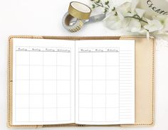 an open planner book sitting on top of a table