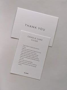 two folded cards with the words, thank you and candle care guide written on them