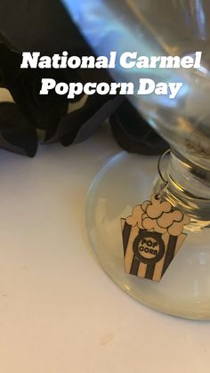 a glass filled with popcorn sitting on top of a table