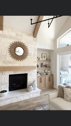 a living room filled with furniture and a fire place in front of a large window