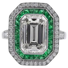 Sophia D's Art Deco inspired platinum ring that features an emerald cut diamond weighing 2.84 carats accented by small round diamonds with the total weight of 0.31 carat and French cut green emeralds weighing 0.50 carats. Sophia D by Joseph Dardashti LTD has been known worldwide for 35 years and are inspired by classic Art Deco design that merges with modern manufacturing techniques. Diamond Emerald Ring, Emerald Cut Diamond Ring, Platinum Diamond Rings, Diamond Engagement Wedding Ring, Emerald Diamond Ring, Emerald Cut Diamond, Deco Engagement Ring, Bling Rings, Deco Jewelry