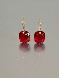 Beautiful red ruby earrings in Brilliant drops. The faceted rectangle drops have an amazing bright red color and are attached to 24K Gold Vermeil/ 14K SOLID GOD  ear wires.  The earrings are elegant, minimalist, and perfect to go with any outfit.   A truly gorgeous pair of earrings. When 14K SOLID GOLD ear wires are being used, the ear wire ends are hand stamped as proof of being 14K solid gold. In addition, extra work was done at the end of the ear wires to prevent any sort of pain or injury wh Red Fine Jewelry Earrings For Party, Cushion Cut Ruby Jewelry Gift, Cushion Cut Ruby Jewelry For Gift, Cushion Cut Ruby Jewelry As Gift, Red Faceted Earrings For Formal Occasions, Red Square Cut Jewelry For Gift, Red Square Cut Jewelry Gift, Red Square Cut Gemstone Jewelry, Red Cushion Cut Ruby Jewelry