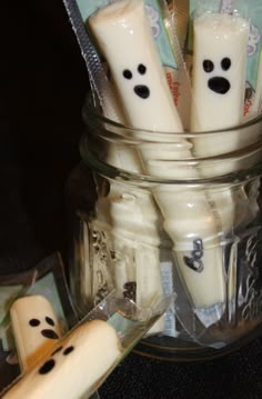 toothbrushes decorated with faces and eyes in a jar